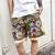 Men's fashion streetwear with sunflower embroidered shorts, oversized zip hoodie, and big watches0